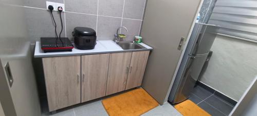 a small bathroom with a sink and a shower at Sweethome Mummy@Youthcity Nilai in Nilai