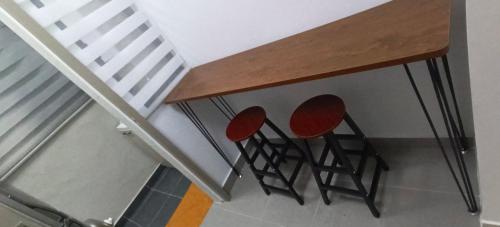 a table and two chairs under a staircase at Sweethome Mummy@Youthcity Nilai in Nilai