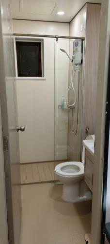 a small bathroom with a toilet and a shower at Sweethome Mummy@Youthcity Nilai in Nilai
