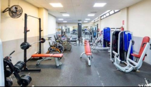 a gym with a bunch of exercise equipment in it at Parque lagos granada in Granada