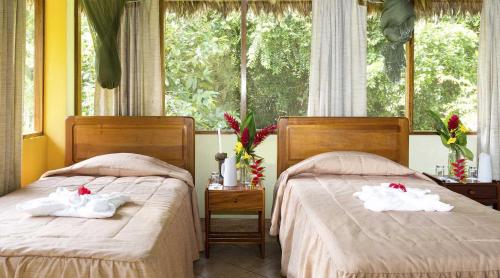 Postel nebo postele na pokoji v ubytování Tambopata Ecolodge
