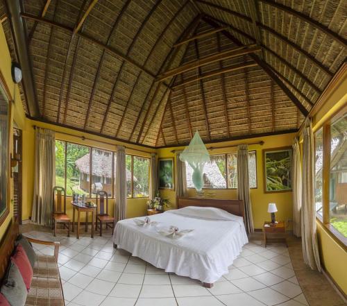a bedroom with a bed in a room with yellow walls at Tambopata Ecolodge in Tambopata