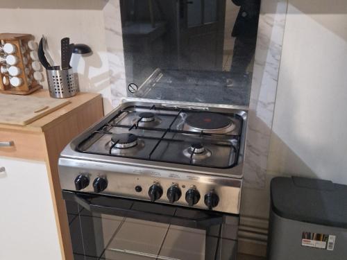 a stove top oven sitting in a kitchen at Maison calme avec 3 chambres, proche centre-ville Lunéville & gare, accès facile à Nancy - FR-1-584-106 in Lunéville