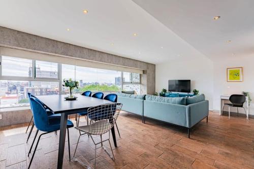 a living room with a couch and a table and chairs at Family friendly Roma Condo 247 Security Parking in Mexico City