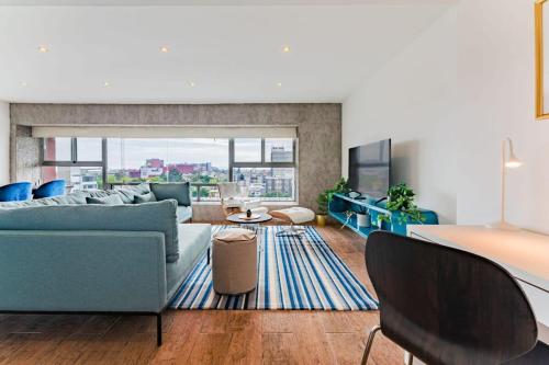 a living room with a couch and a table at Family friendly Roma Condo 247 Security Parking in Mexico City