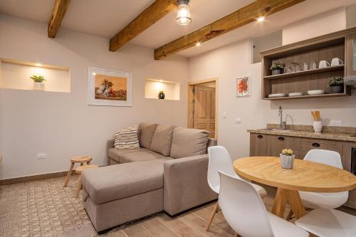 a living room with a couch and a table at Casa Pandurata Luxury Apartments in Centro, San Miguel de Allende in San Miguel de Allende