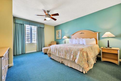 a bedroom with a bed and a ceiling fan at Ocean Walk Condominiums in Daytona Beach