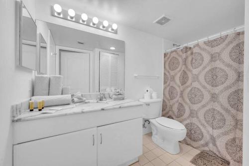 a white bathroom with a sink and a toilet at Stunning 1 BDR 1 BTH • Brickell • Bay & City Views in Miami