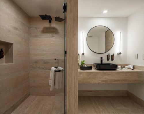 a bathroom with a sink and a mirror at Hotel Elements by Marquis in Mexico City