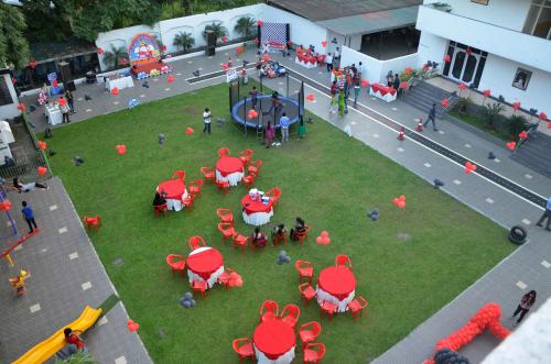 an aerial view of a park with tables and chairs at The Cindrella Hotel in Siliguri
