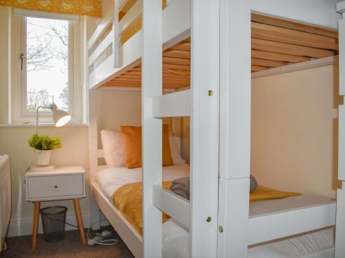 a bunk bed in a small room with a bunk bed in a house at Sycamore Cottage in Broomhill
