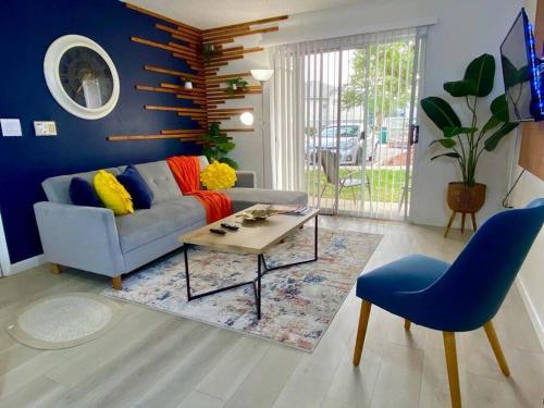 a living room with a couch and a table at The Botanical Retreat, King Comfort & Poolside Peace in Gainesville