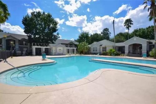 a large swimming pool at a resort at The Botanical Retreat, King Comfort & Poolside Peace in Gainesville
