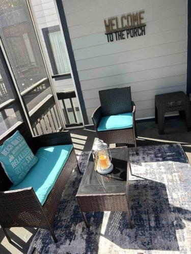a porch with wicker chairs and a table and a chair at Ocean Breeze Beachfront Condo, Newly Renovated in Myrtle Beach