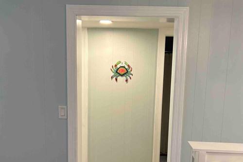 a hallway with a door with a painting on the wall at Ocean Breeze Beachfront Condo, Newly Renovated in Myrtle Beach