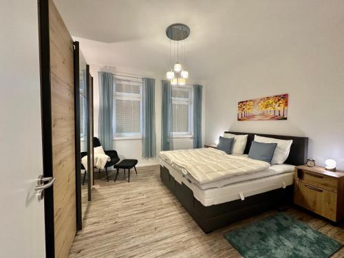 a bedroom with a bed and a chair in it at Haus Concordia 2 Phönix in Thiessow
