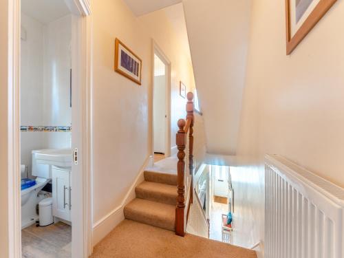 a staircase in a home with white walls at Casa Musica in Broadstairs