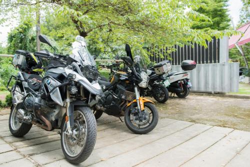 a group of motorcycles parked next to each other at Nunou Cafe in Ban Than Lao