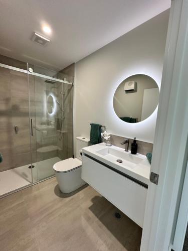 a bathroom with a toilet and a sink and a shower at Stylish 3-bed Taradale Townhouse in Napier