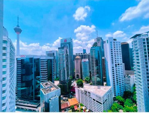 a view of a city skyline with tall buildings at Cool And Cozy Home By Seri Bukit Ceylon Residency in Kuala Lumpur