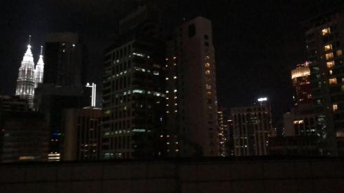 a city skyline at night with tall buildings at Cool And Cozy Home By Seri Bukit Ceylon Residency in Kuala Lumpur