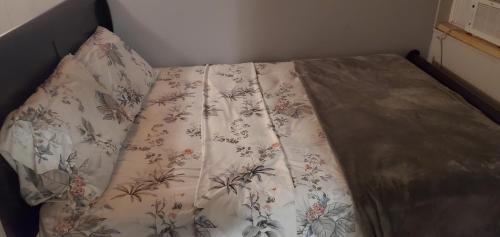 a bed with a blanket on it in a bedroom at Private Studios Orlando in Orlando