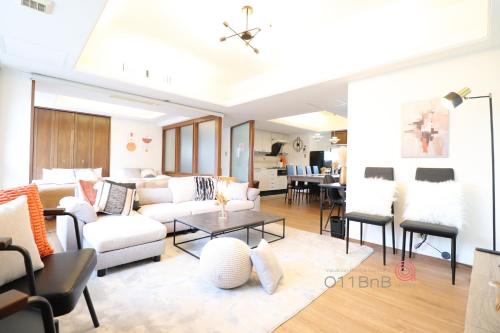 a living room with white furniture and a table at NK BLD8F Sapporo 3LDK 3BR 1 floor 1 room in Sapporo