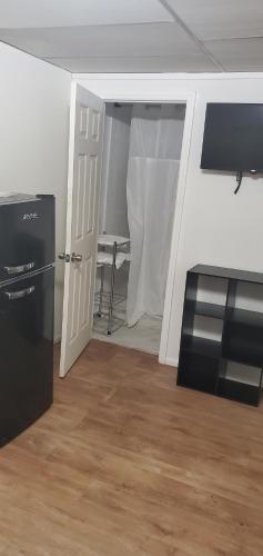 an empty room with a door and a kitchen with a table at Private Studios Orlando in Orlando