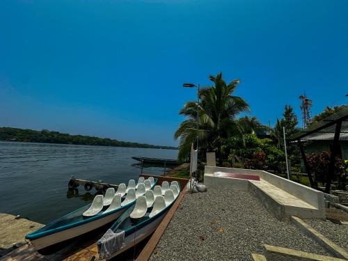 a group of boats sitting on the water at Tortuguero7 lake view in Tortuguero