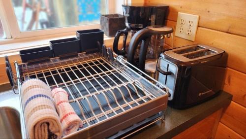 a kitchen counter with a drying rack and a toaster at Mt. Revelstoke Alpine Chalets in Revelstoke
