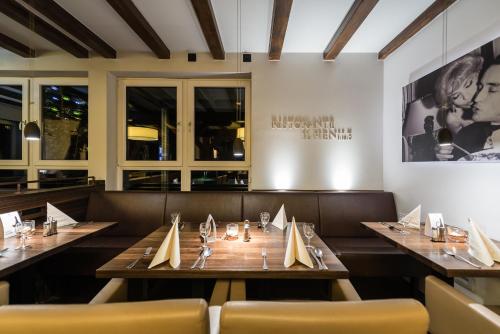 a dining room with wooden tables and chairs at Landhotel Burg im Spreewald - Resort & Spa in Burg