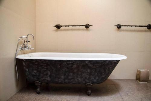 a bathroom with a bath tub in a room at Casa Carondelet Spanish Colonial Home in Quito