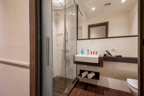 a bathroom with a shower and a sink at Corso Grand Suite in Rome