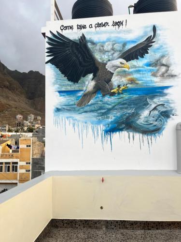 a painting of an eagle flying over the water at Casa BB&Djassi in Ponta do Sol