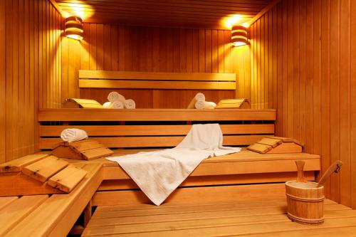 a sauna with two beds and towels in it at Ferienland Stubai in Fulpmes