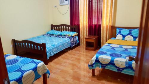 a room with two beds in a room at TGH Guest House Badian in Badian