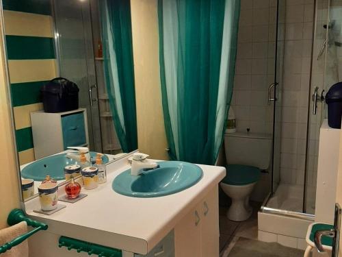 a bathroom with a blue sink and a shower at Maison Valras-Plage, 3 pièces, 4 personnes - FR-1-781-39 in Valras-Plage