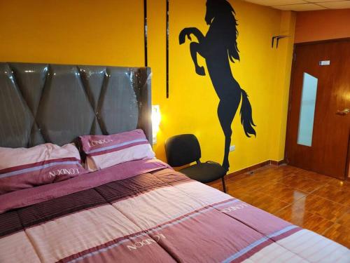 a bedroom with a bed with a mermaid painted on the wall at Apartamento Panorámico in Cajamarca