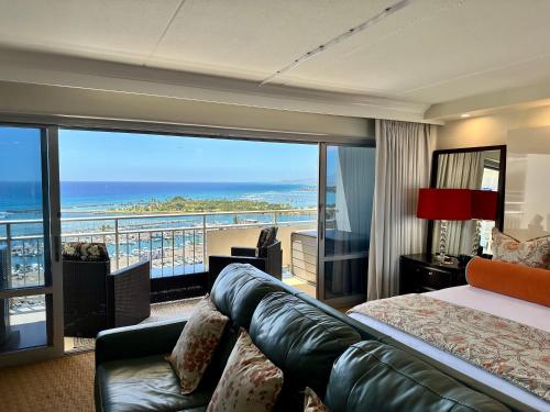 a hotel room with a bed and a view of the ocean at Serenity Waikiki ! Luxury Ocean Suite ! in Honolulu