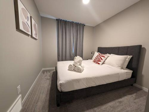 a bedroom with a bed with two speakers on it at Luxury Villa Home in Edmonton