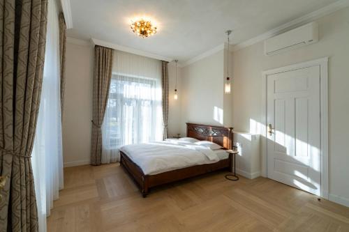 a bedroom with a bed and a window at Villa Langberg Spa in Ventspils