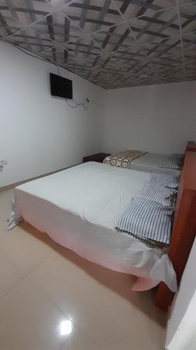 a bedroom with a bed with a tv on the ceiling at Vidatha Villa in Bandarawela