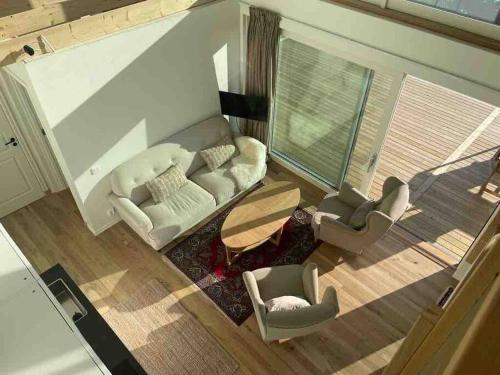 an overhead view of a living room with a couch and chairs at Sea side villa with breathtaking view in Gothenburg