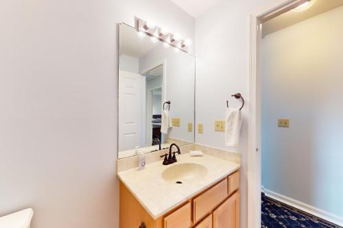a bathroom with a sink and a large mirror at Maplewood --- 30 Bryn Mawr Dr. in Rehoboth Beach