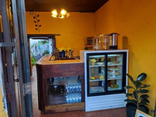 a kitchen with a refrigerator with drinks in it at Hotel Casa Nikté in Antigua Guatemala