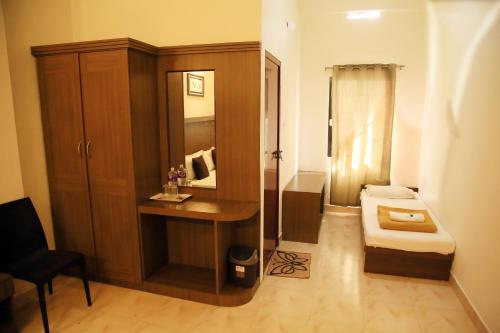 a bathroom with a toilet and a sink and a mirror at Highrange Plaza in Thekkady