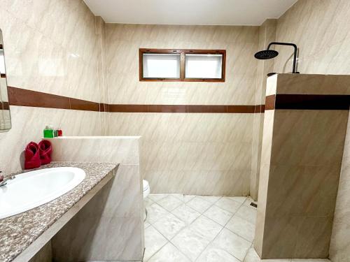 a bathroom with a sink and a shower at Amara Beach Resort Koh Phangan in Haad Yao