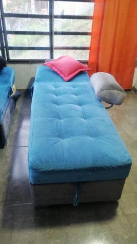 a large blue bed sitting in a room at Apartamento hermosa vista in Líbano