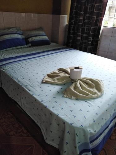 a bed with a bowl and towels on it at Hospedaje Kennedy in Pucallpa