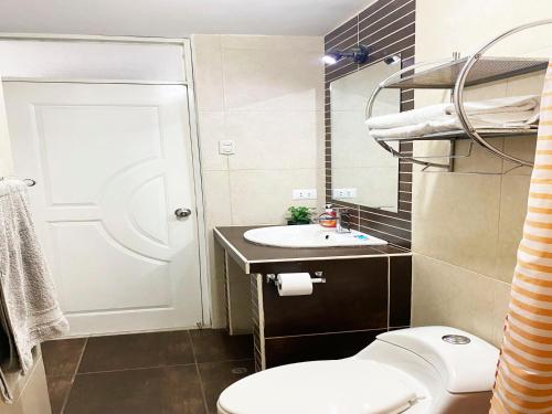 a small bathroom with a toilet and a sink at Ayli Apart Hotel in Arequipa